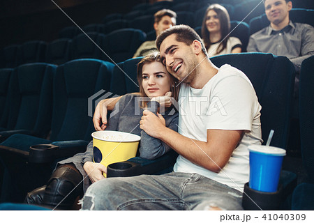 Smiling couple watching comedy movie in cinema 41040309