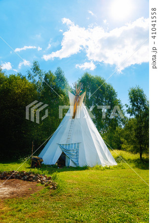 white teepee indian tent standing in beautiful summer landscape. 41041558