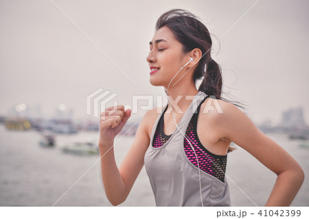Sports concept. Beautiful girl is exercising on the beach with r Sports concept. Beautiful girl is exercising on the beach with r 41042399