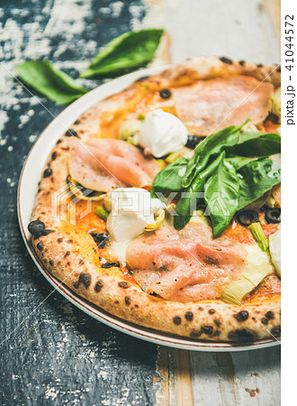 Freshly baked pizza with ham, artichokes and cream cheese, close-up 41044572