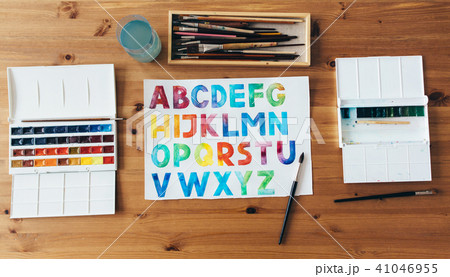 Painter workplace top view. Wooden table of an artist with art tools for drawing. Painter workplace top view. Wooden table of an artist with art tools for drawing. 41046955