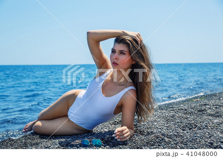 Woman sunbathing on the beach Woman sunbathing on the beach 41048000