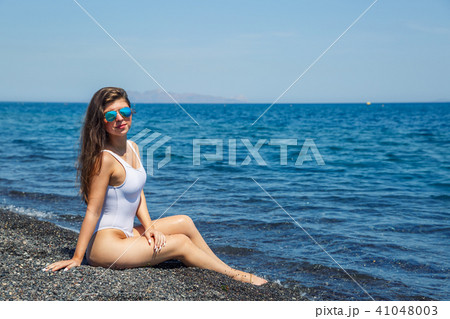Woman sunbathing on the beach Woman sunbathing on the beach 41048003