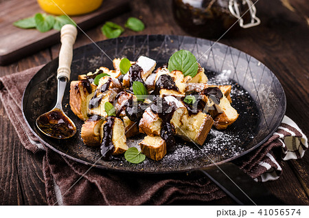 Cutted pancakes, Kaiserschmarrn delish dessert with plums 41056574
