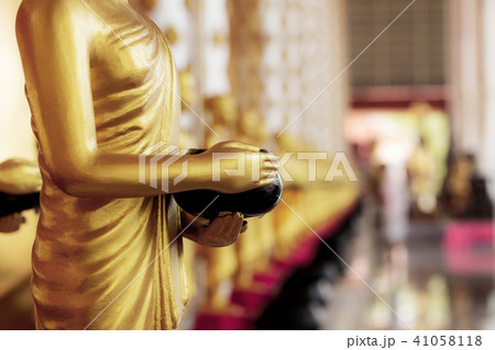 Buddha statue holding alms. Buddha statue holding alms. 41058118