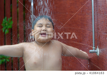 Happy obese boy taking shower before swimming 41064163