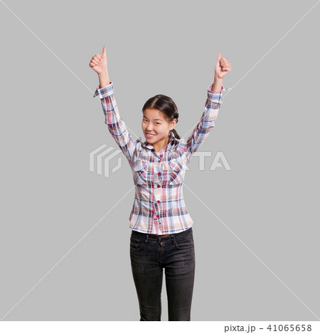 Winning concept. Asian girl shows well done Winning concept. Asian girl shows well done 41065658