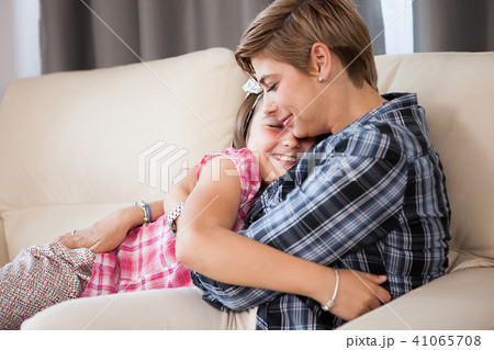Cute teenage daughter in arms of her mother 41065708