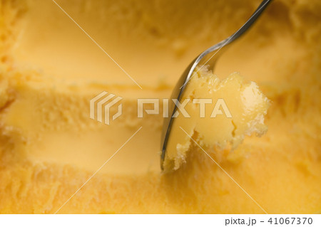 scooping with spoon orange sorbet 41067370