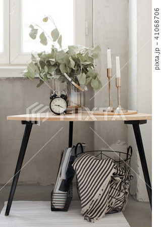 Green branches and candles on side table 41068706