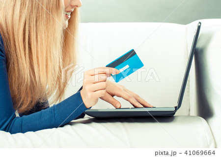 Woman with credit card paying over internet 41069664
