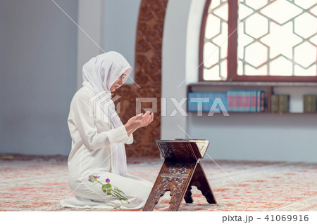 Young beautiful Muslim Woman Praying In Mosque 41069916