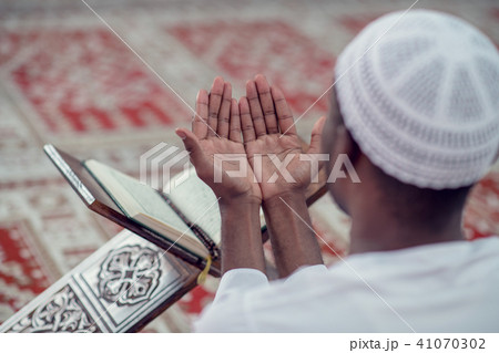 African Muslim Man Making Traditional Prayer To God While Wearing Dishdasha 41070302