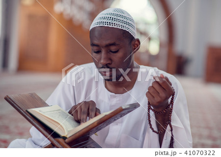 African Muslim Man Making Traditional Prayer To God While Wearing Dishdasha 41070322