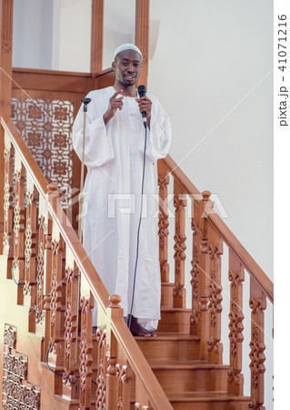 Muslims black african Imam has a speech on friday afternoon prayer in a mosque 41071216