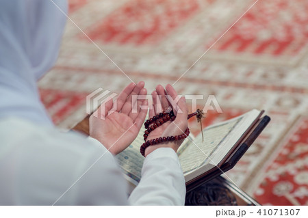 Young beautiful Muslim Woman Praying In Mosque Young beautiful Muslim Woman Praying In Mosque 41071307