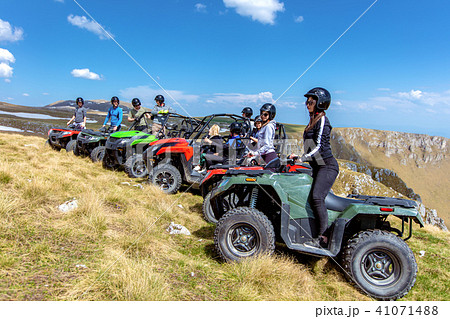 Friends driving off-road with quad bike or ATV and UTV vehicles 41071488