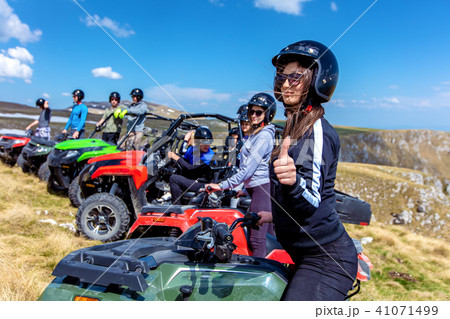Friends driving off-road with quad bike or ATV and UTV vehicles Friends driving off-road with quad bike or ATV and UTV vehicles 41071499