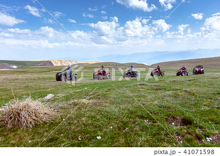 Friends driving off-road with quad bike or ATV and UTV vehicles Friends driving off-road with quad bike or ATV and UTV vehicles 41071598