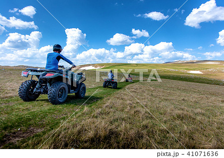 Friends driving off-road with quad bike or ATV and UTV vehicles 41071636