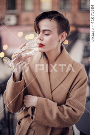 Stylish woman is standing on the balcony Stylish woman is standing on the balcony 41071984