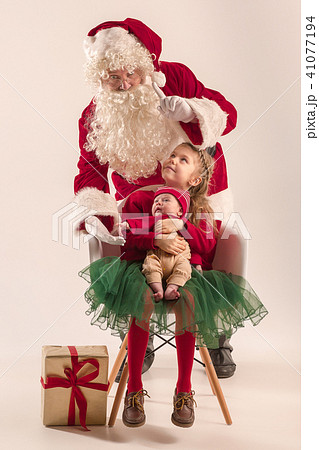Christmas portrait of cute little newborn baby girl, dressed in christmas clothes, studio shot Christmas portrait of cute little newborn baby girl, dressed in christmas clothes, studio shot 41077194