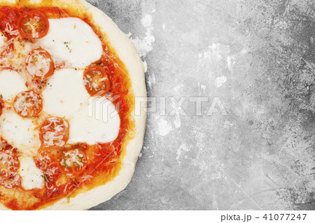 Pizza with cheese, tomatoes and basil Pizza with cheese, tomatoes and basil 41077247