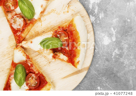Pizza with cheese, tomatoes and basil Pizza with cheese, tomatoes and basil 41077248
