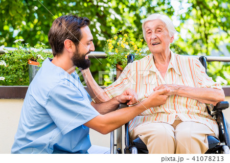 Geriatric nurse holding hand of old woman in rest home Geriatric nurse holding hand of old woman in rest home 41078213
