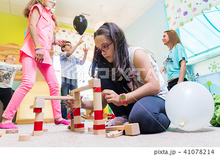 Cute girl building a structure in balance during playtime at the kindergarten 41078214