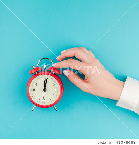 Woman hand holding the red vintage alarm clock Woman hand holding the red vintage alarm clock 41078488