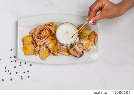 Beautiful white flat lay with a candle and  rose 41080102
