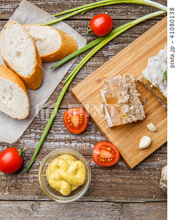 Homemade jelly meat with mustard, bread, tomatoes and garlic on the table. Holodets Homemade jelly meat with mustard, bread, tomatoes and garlic on the table. Holodets 41080138