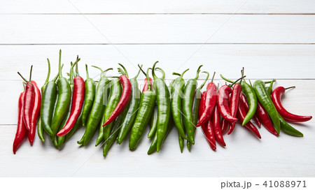 a colorful mix of the freshest and hottest chili peppers on wooden table 41088971
