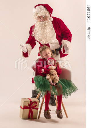 Christmas portrait of cute little newborn baby girl, dressed in christmas clothes, studio shot 41091864