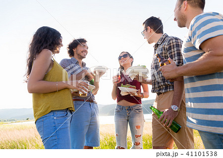 Young men and women on BBQ party in country 41101538