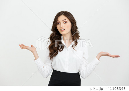 Business woman surprise showing product. Beautiful girl holding hand to the side Business woman surprise showing product. Beautiful girl holding hand to the side 41103343