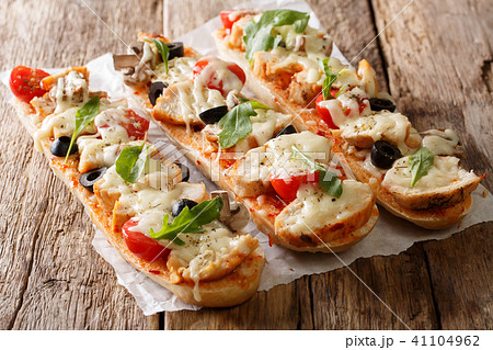 Hot tasty cut baguette baked with chicken, cheese 41104962