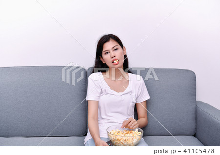 The concept of watching television. Asian girls watching televis 41105478