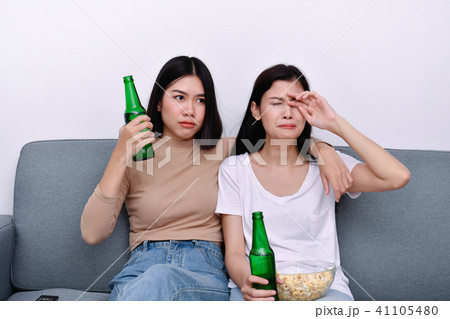 The concept of watching television. Asian girls watching televis The concept of watching television. Asian girls watching televis 41105480