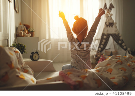 child girl wakes up and stretches in morning child girl wakes up and stretches in morning 41108499