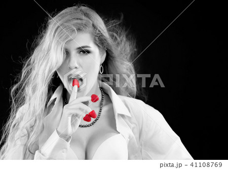 Woman eating berry. Pin up girl wearing unbuttoned blouse and bra. Woman eating berry. Pin up girl wearing unbuttoned blouse and bra. 41108769