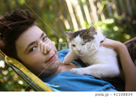 teenager boy with cat in hummock nap 41108834