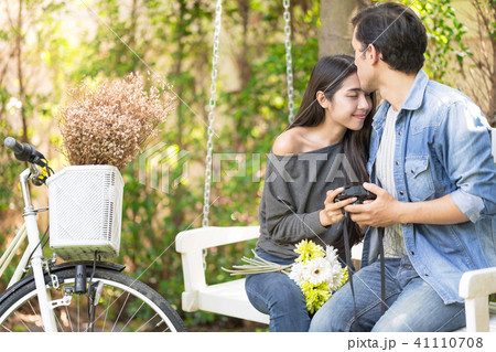 Sweet Love Couple Cycling to Picnic in the Garden. Sweet Love Couple Cycling to Picnic in the Garden. 41110708