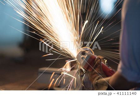 Man use electric Steel cutter and clamp metal. Man use electric Steel cutter and clamp metal. 41111140