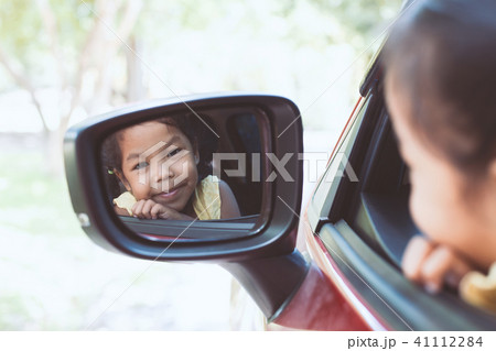 Cute asian little child girl traveling by car Cute asian little child girl traveling by car 41112284