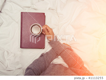 beautiful young woman drinking coffee at home in her bed wearin beautiful young woman drinking coffee at home in her bed wearin 41113255