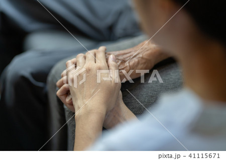Hand of younger woman holding hand elderly man 41115671
