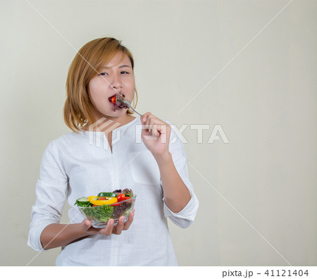 beautiful woman standing holding bowl of salad beautiful woman standing holding bowl of salad 41121404