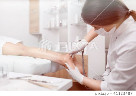 Woman relaxing at beauty salon, when podiatrist making procedure 41123487